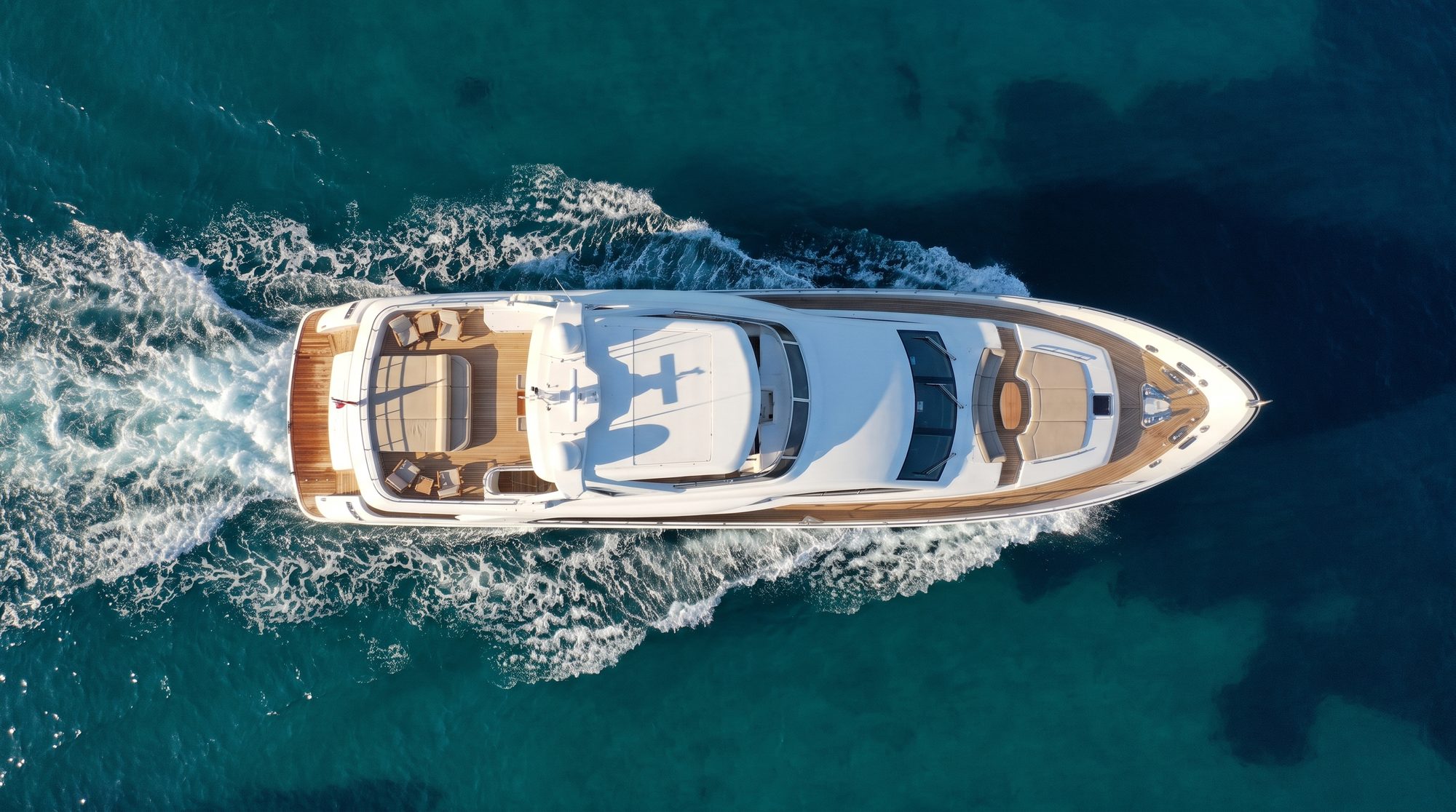 Motor yacht under way on open Mediterranean water, seen from directly above